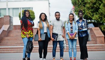 group-five-african-college-students-spending-time-together-campus-university-yard-black-afro-friends-studying-education-theme-1-scaled.jpg